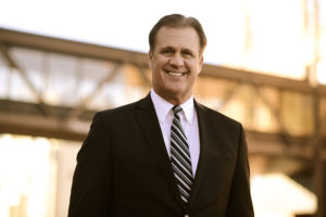 NCU President Scott Hagan standing in front of the skyway during sunset