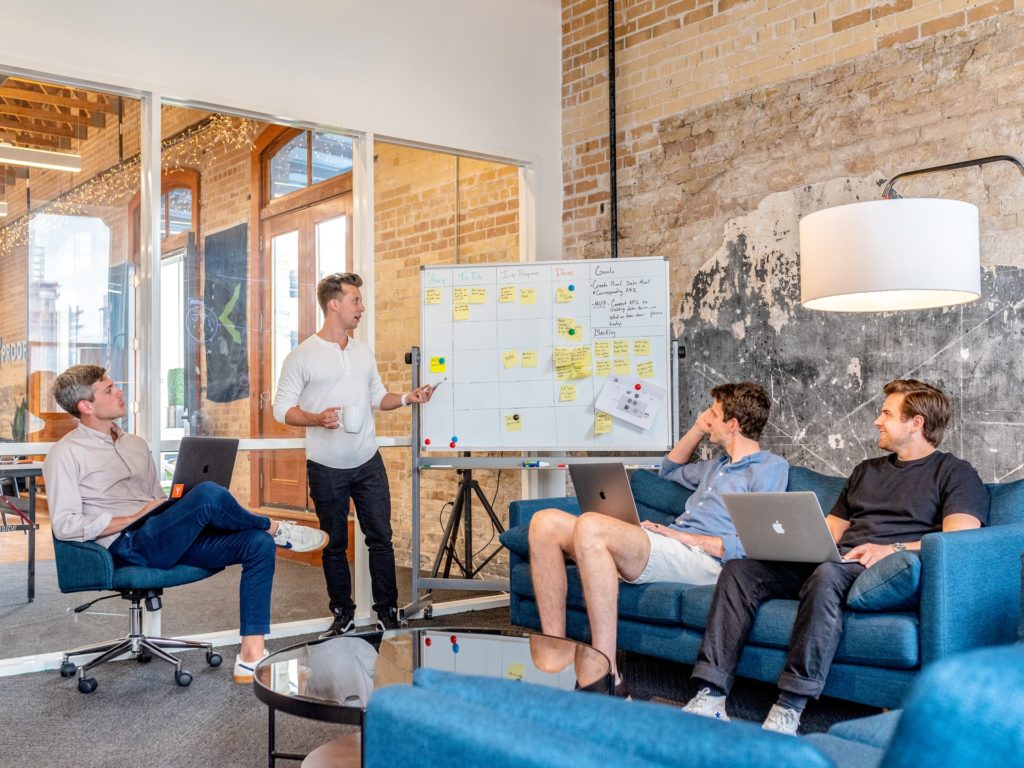 four people having a meeting